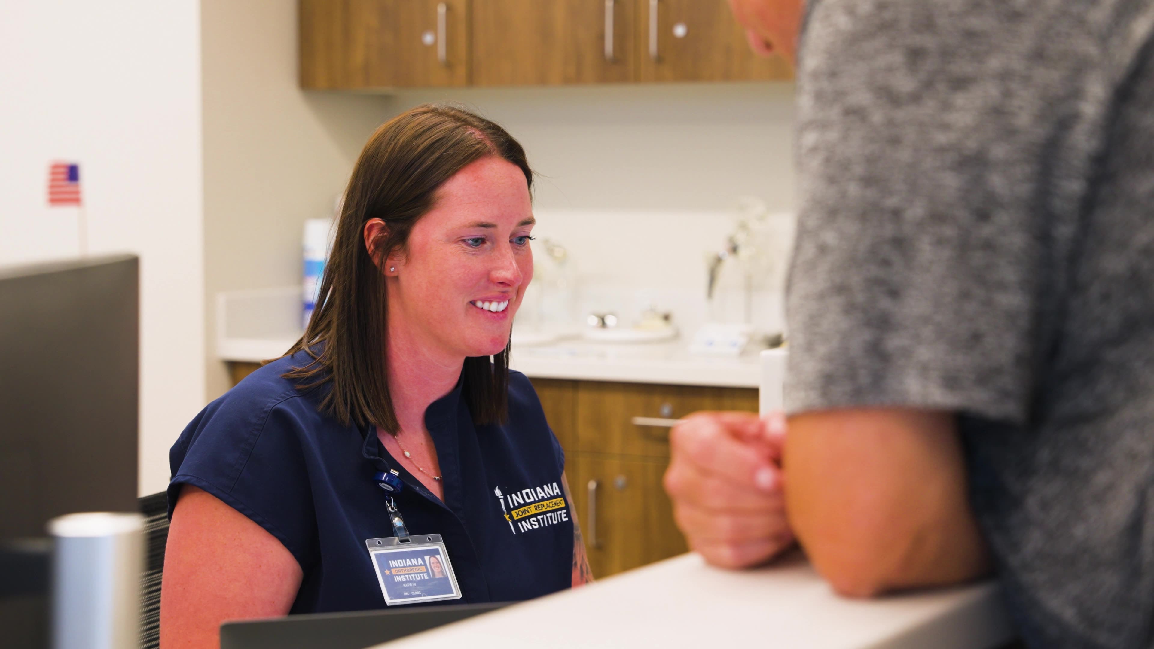 Indiana Orthopedic Institute care team member helping a patient at check-in